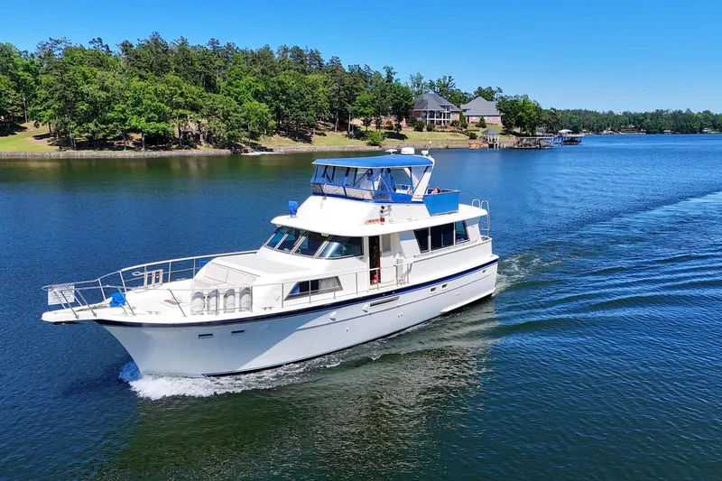 Slide: The Image of 1984 Hatteras 53 Extended Deckhouse Motor Yacht cruising on a serene lake. - 103