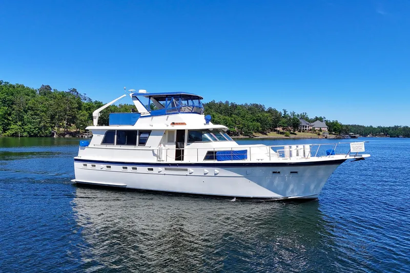 Slide: The Image of 1984 Hatteras 53 Extended Deckhouse Motor Yacht cruising on a serene lake. - 104