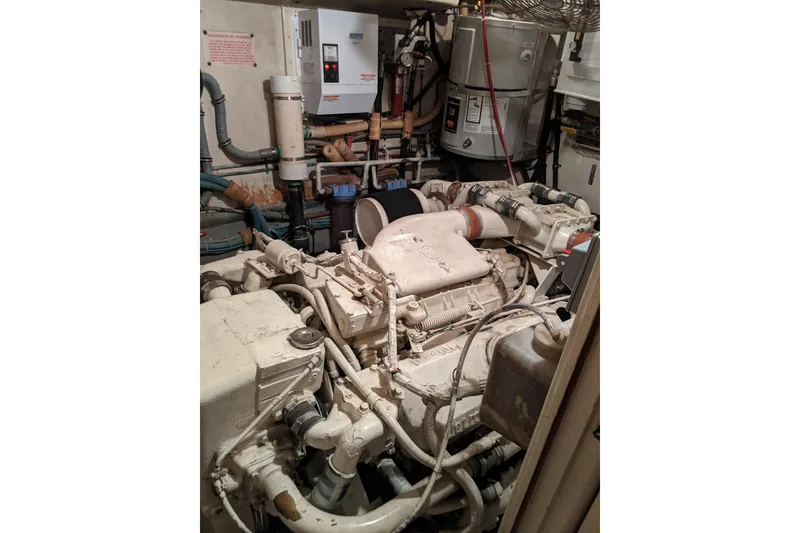 Slide: The Image of Engine room of 1984 Hatteras 53 Extended Deckhouse Motor Yacht, showcasing mechanical components. - 12