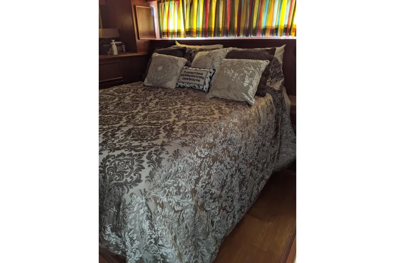 Slide: The Image of Luxurious bedroom interior of 1984 Hatteras 53 Extended Deckhouse Motor Yacht with elegant bedding. - 16