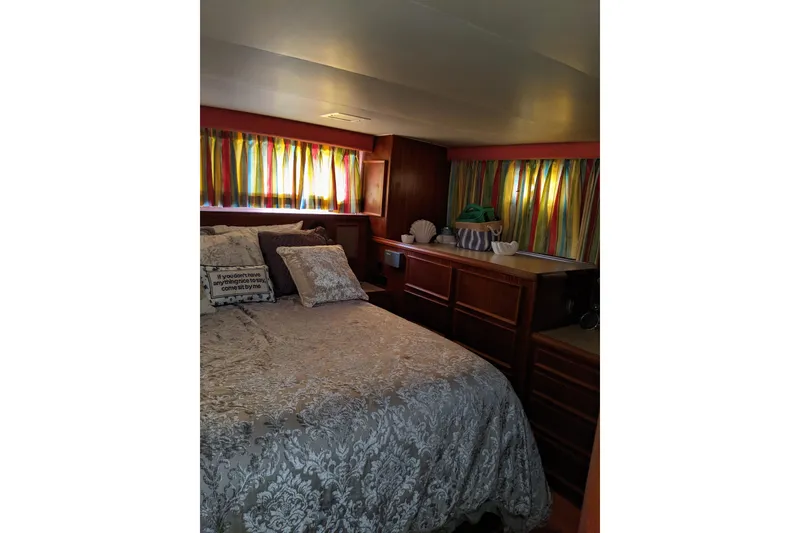 Slide: The Image of Cozy bedroom in 1984 Hatteras 53 Motor Yacht with colorful curtains and elegant bedding. - 20