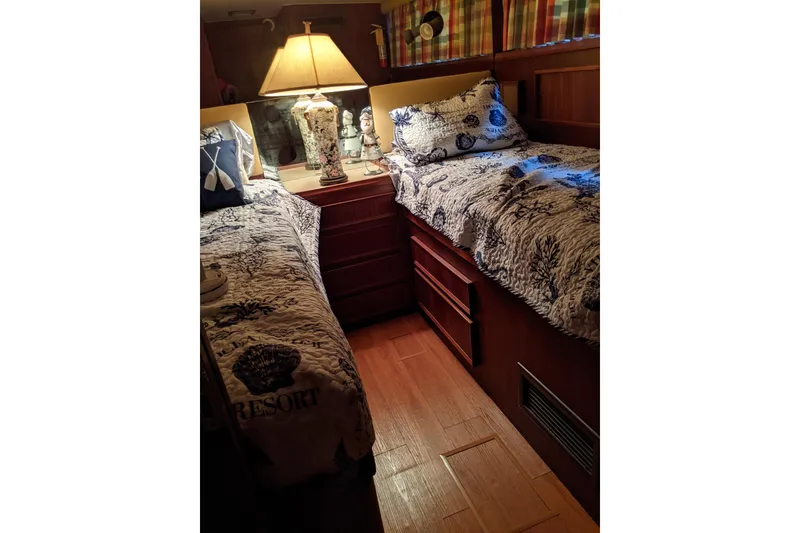 Slide: The Image of Cozy twin cabin in 1984 Hatteras 53 Motor Yacht with nautical decor and warm lighting. - 22