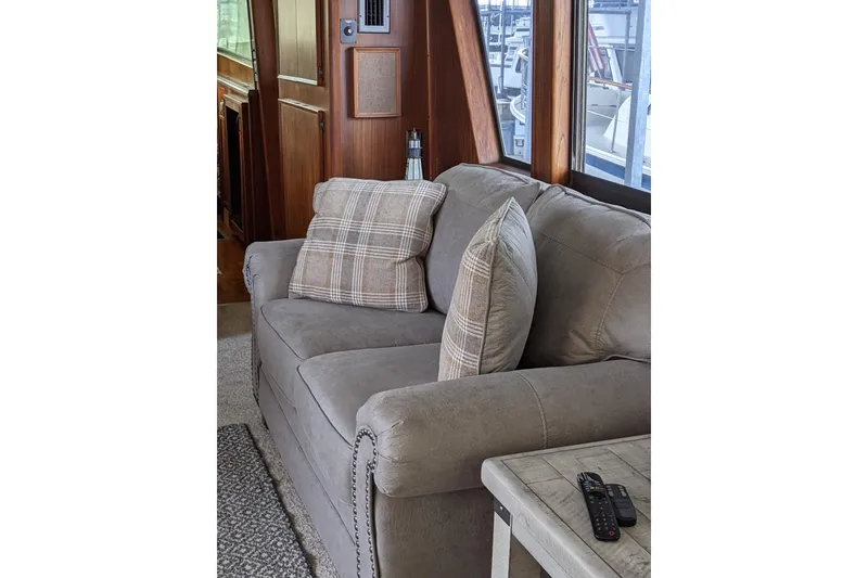 Slide: The Image of Interior of 1984 Hatteras 53 Yacht with cozy sofa and plaid cushions. - 28