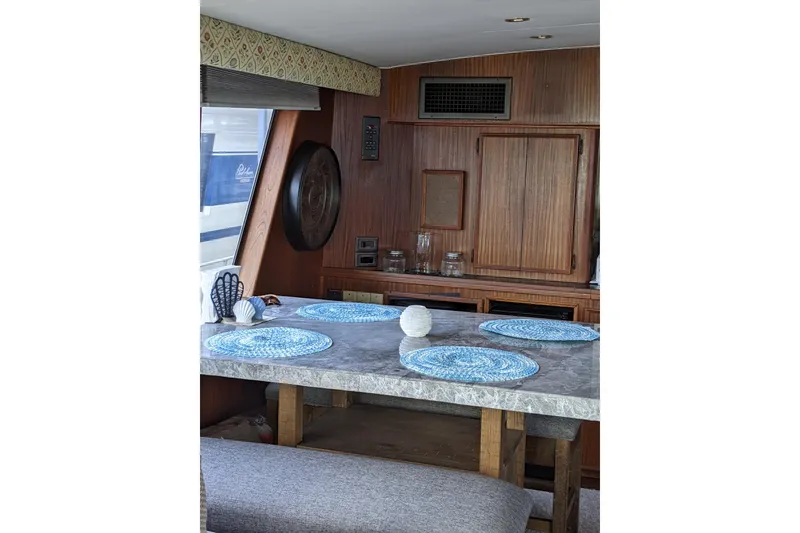 Slide: The Image of Interior of 1984 Hatteras 53 Motor Yacht with dining area and wooden cabinetry. - 29