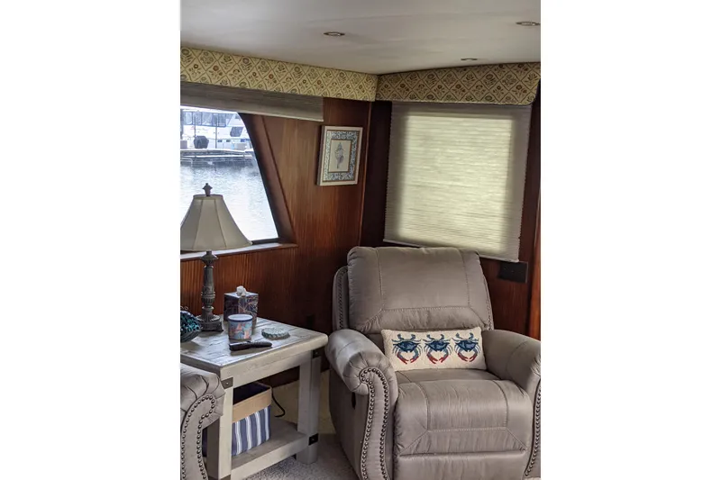 Slide: The Image of Interior of 1984 Hatteras 53 Yacht with cozy seating and nautical decor. - 34