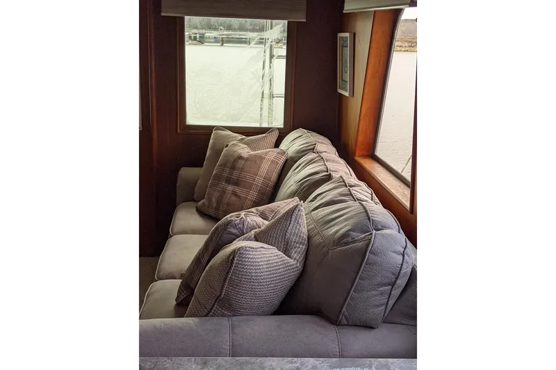 Slide: The Image of Luxurious interior of 1984 Hatteras 53 Motor Yacht with plush seating and scenic window view. - 35