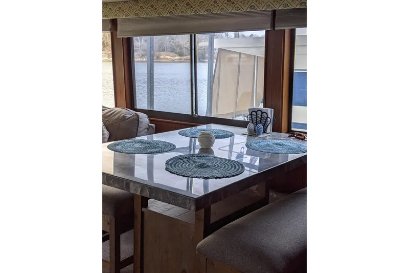 Slide: The Image of Interior of 1984 Hatteras 53 Motor Yacht with dining area and scenic window view. - 36