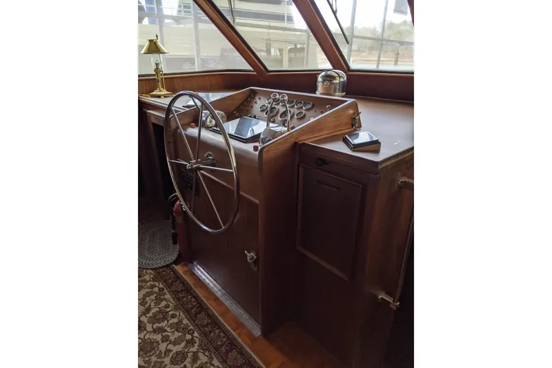 Slide: The Image of 1984 Hatteras 53 Motor Yacht helm with wooden dashboard and steering wheel. - 40