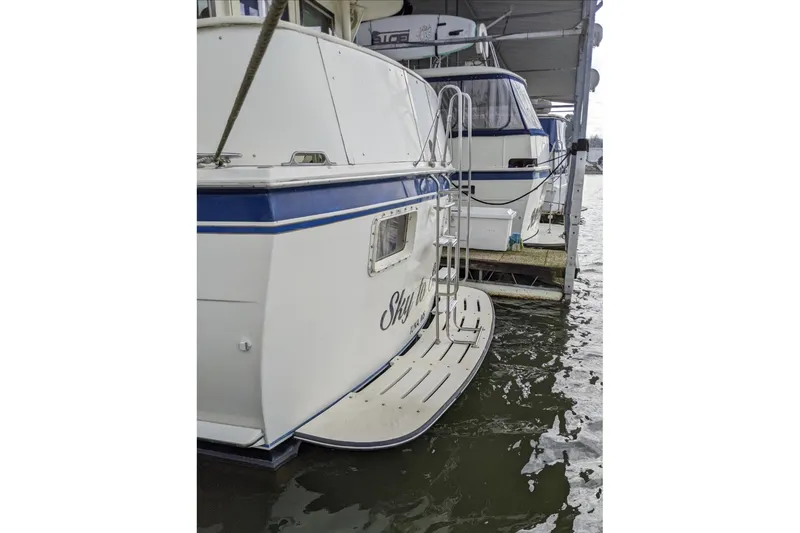 Slide: The Image of 1984 Hatteras 53 Extended Deckhouse Motor Yacht docked, rear view with swim platform. - 42