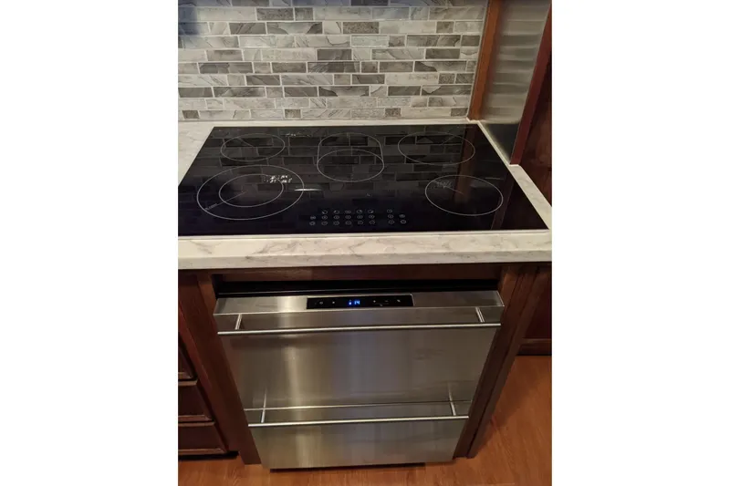 Slide: The Image of Modern kitchen with electric cooktop and stainless steel oven on Hatteras 53 Motor Yacht. - 45