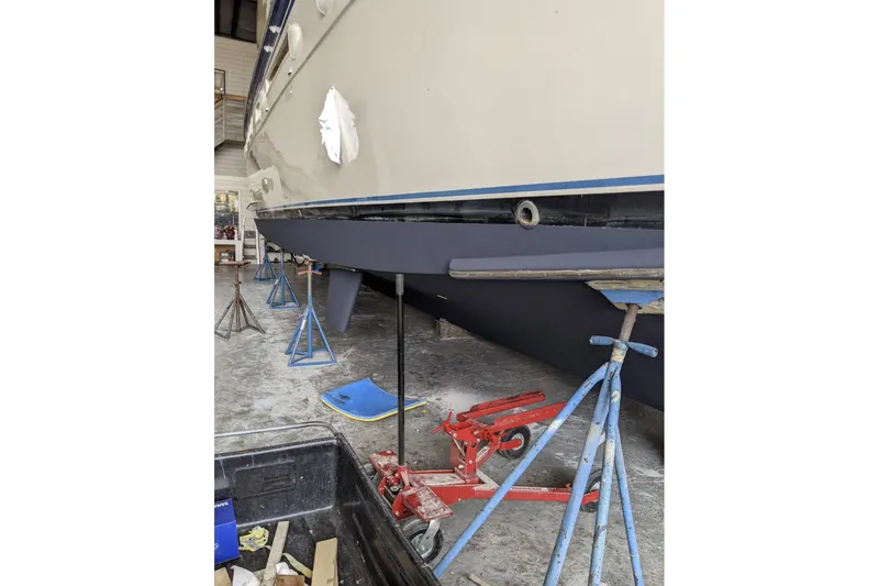 Slide: The Image of 1984 Hatteras 53 Extended Deckhouse Motor Yacht in dry dock, supported by stands. - 49