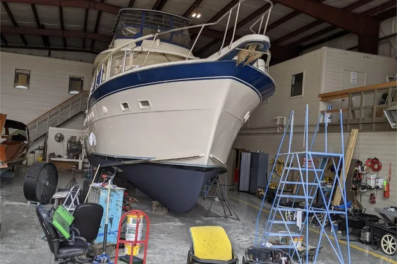 Slide: The Image of 1984 Hatteras 53 Extended Deckhouse Motor Yacht in a maintenance facility. - 51
