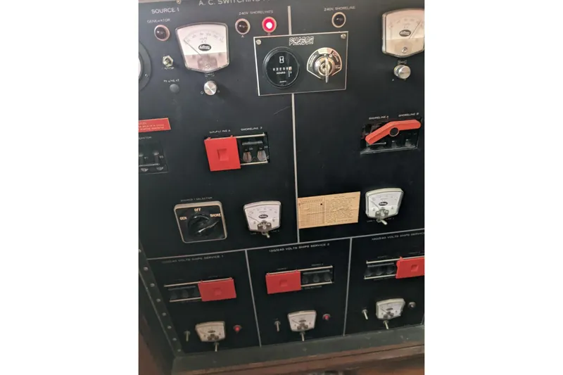 Slide: The Image of Control panel of a 1984 Hatteras 53 Extended Deckhouse Motor Yacht, featuring gauges and switches. - 52