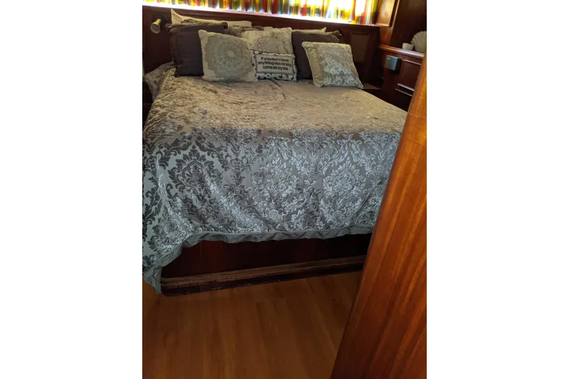 Slide: The Image of Cozy bedroom with patterned bedding on 1984 Hatteras 53 Extended Deckhouse Motor Yacht. - 54