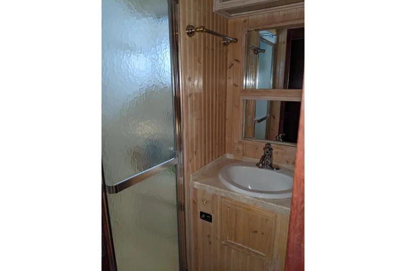 Slide: The Image of Bathroom interior of 1984 Hatteras 53 Extended Deckhouse Motor Yacht with wood paneling and shower. - 56