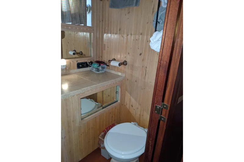 Slide: The Image of Bathroom interior of 1984 Hatteras 53 Extended Deckhouse Motor Yacht with wood paneling and mirror. - 57