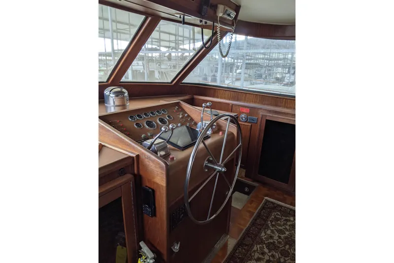 Slide: The Image of 1984 Hatteras 53 Extended Deckhouse Motor Yacht helm with wooden dashboard and steering wheel. - 6