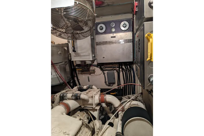 Slide: The Image of Engine room of 1984 Hatteras 53 Extended Deckhouse Motor Yacht with machinery and control panels. - 75