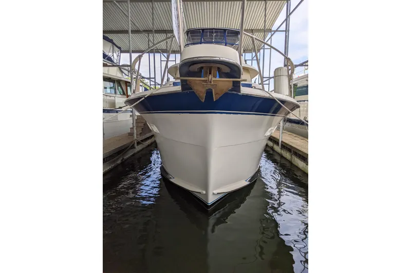 Slide: The Image of 1984 Hatteras 53 Extended Deckhouse Motor Yacht docked in a marina. - 86