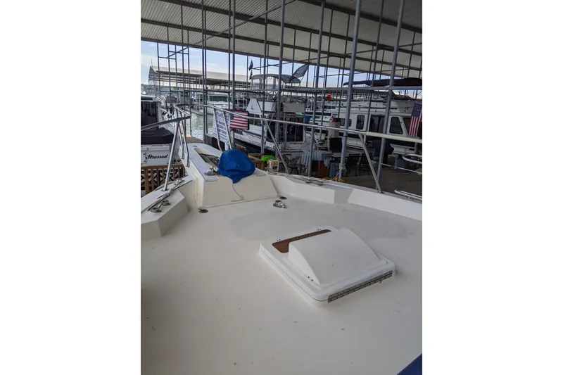 Slide: The Image of 1984 Hatteras 53 Extended Deckhouse Motor Yacht docked in a marina. - 93