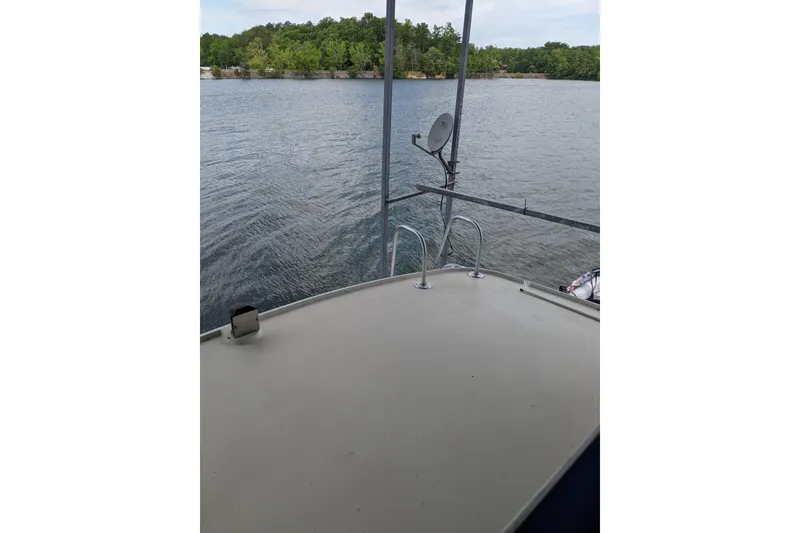 Slide: The Image of 1984 Hatteras 53 Extended Deckhouse Motor Yacht on calm lake with lush shoreline. - 94