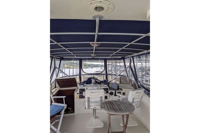 Slide: The Image of 1984 Hatteras 53 Extended Deckhouse Motor Yacht helm with blue canopy and seating. - 95