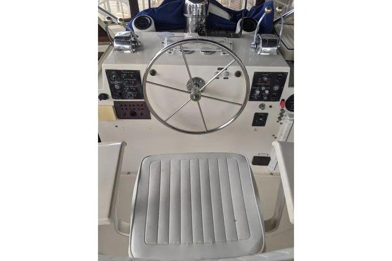 Slide: The Image of Helm of 1984 Hatteras 53 Extended Deckhouse Motor Yacht with steering wheel and controls. - 99