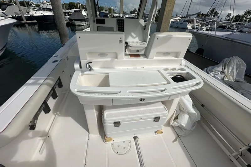 Slide: The Image of 2012 Everglades 295 Center Console boat interior with fishing station and storage. - 13