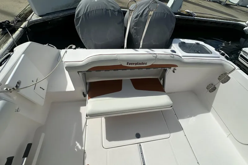 Slide: The Image of 2012 Everglades 295 Center Console boat interior with seating and covered engines. - 14