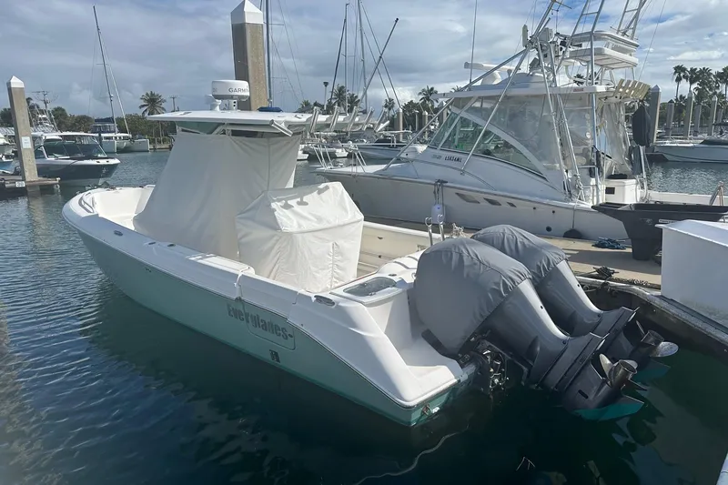 Slide: The Image of 2012 Everglades 295 Center Console boat docked at marina with covered engines. - 15