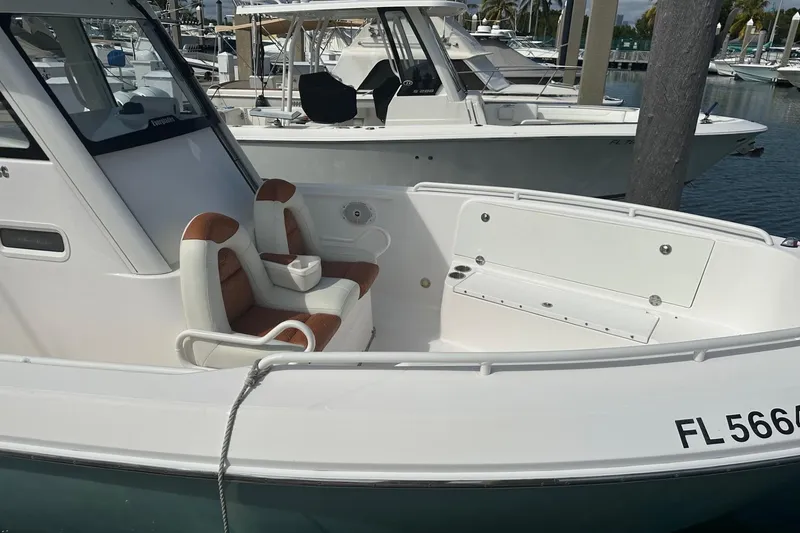 Slide: The Image of 2012 Everglades 295 Center Console boat docked, featuring comfortable seating and sleek design. - 3