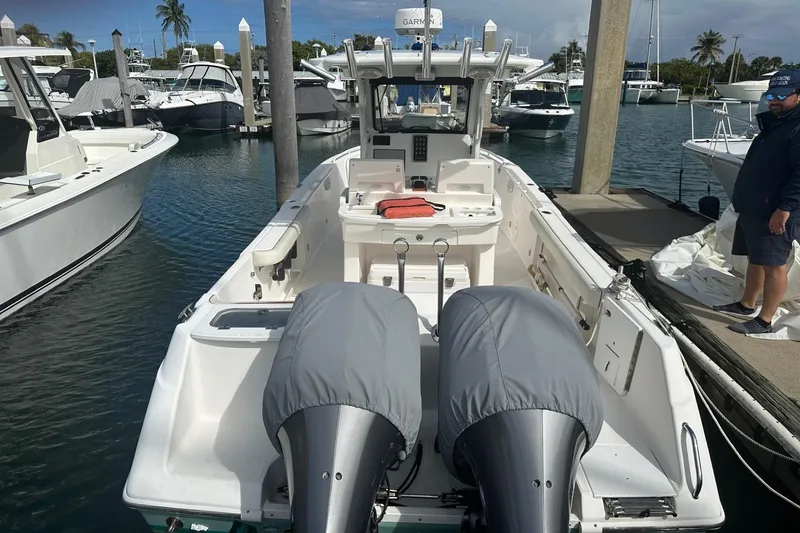 Slide: The Image of 2012 Everglades 295 Center Console boat docked at marina with twin engines. - 5