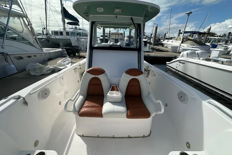 Slide: The Image of 2012 Everglades 295 Center Console boat interior with dual seats at marina. - 8