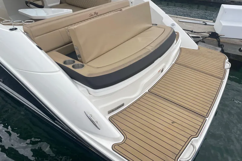 Slide: The Image of 2021 Sea Ray SLX 250 boat with tan seating and swim platform at dock. - 5