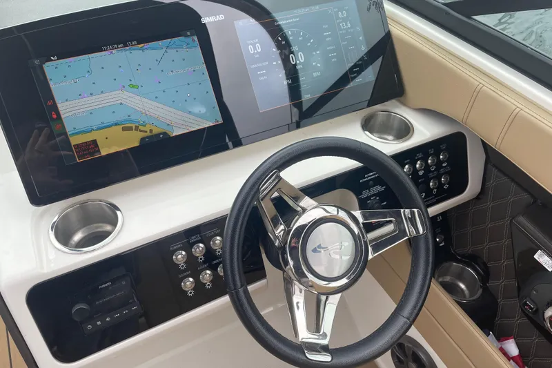 Slide: The Image of 2021 Sea Ray SLX 250 dashboard with navigation screens and steering wheel. - 8