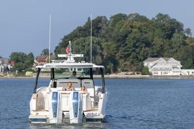 Slide: The Image of 2026 Tiara Yachts 39 LS with dual Mercury outboard engines in showroom. - 2