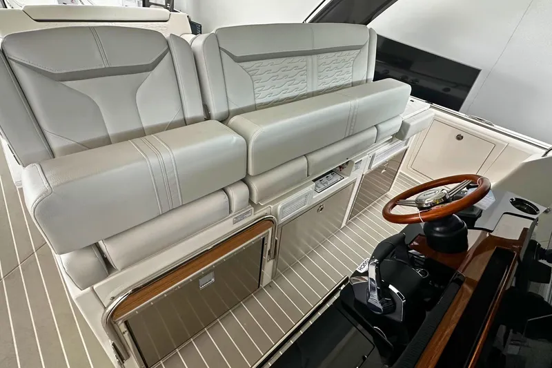 Slide: The Image of 2026 Tiara Yachts 39 LS interior with luxurious seating and sleek steering wheel design. - 21