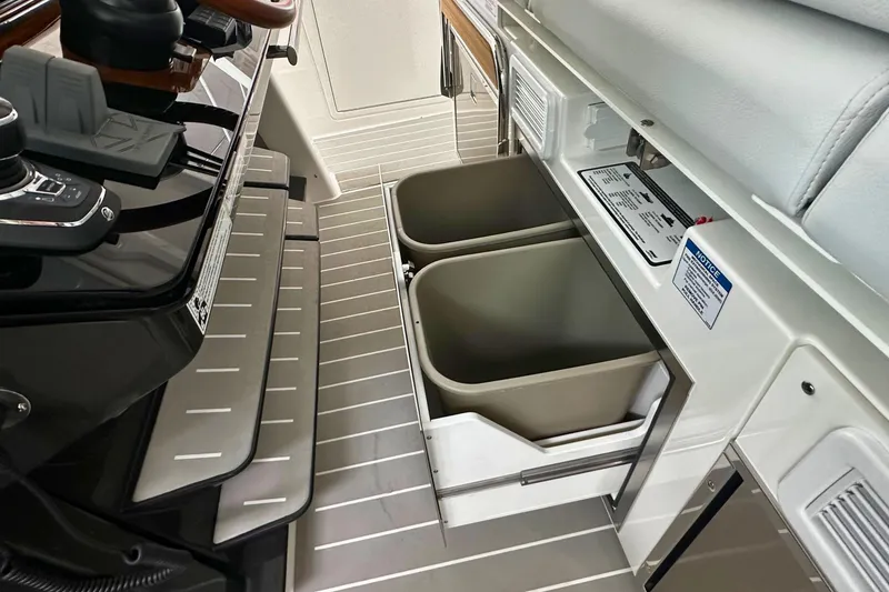 Slide: The Image of 2026 Tiara Yachts 39 LS interior with dual storage bins and control panel. - 25