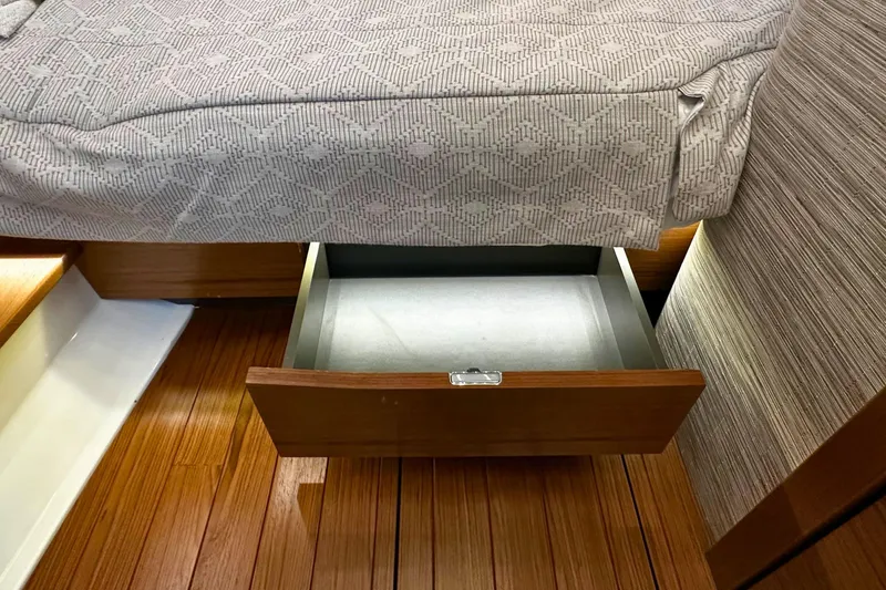 Slide: The Image of Under-bed storage drawer in 2026 Tiara Yachts 39 LS, featuring wooden flooring. - 37