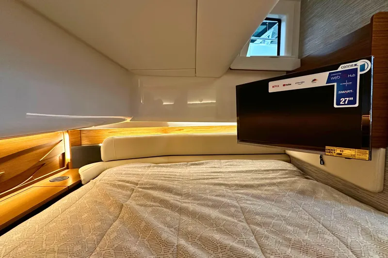 Slide: The Image of Luxurious cabin interior of 2026 Tiara Yachts 39 LS with smart TV and cozy bedding. - 38