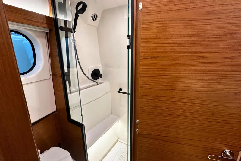 Slide: The Image of Luxurious bathroom in 2026 Tiara Yachts 39 LS, featuring modern shower and wooden accents. - 44