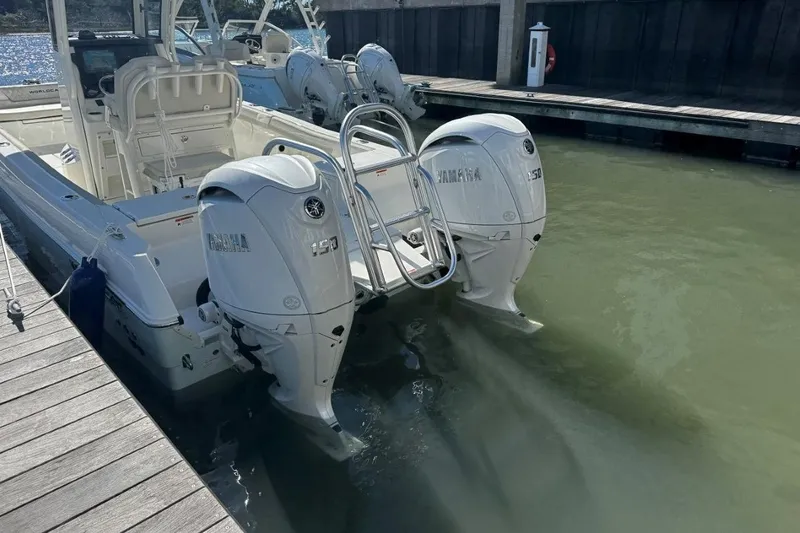 Slide: The Image of 2026 World Cat 235 TE boat with twin Yamaha 150 engines docked in marina. - 3