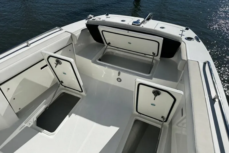 Slide: The Image of 2026 World Cat 235 TE boat interior with open storage compartments on the deck. - 9