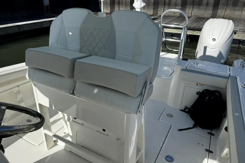 Slide: The Image of 2026 World Cat 235 TE boat interior with dual cushioned seats and steering wheel. - 5