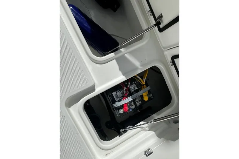 Slide: The Image of Battery compartment of 2026 World Cat 235 TE boat, featuring secure wiring and storage. - 20