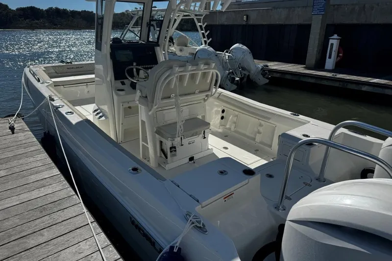 Slide: The Image of 2026 World Cat 235 TE boat docked, showcasing spacious deck and modern design. - 2