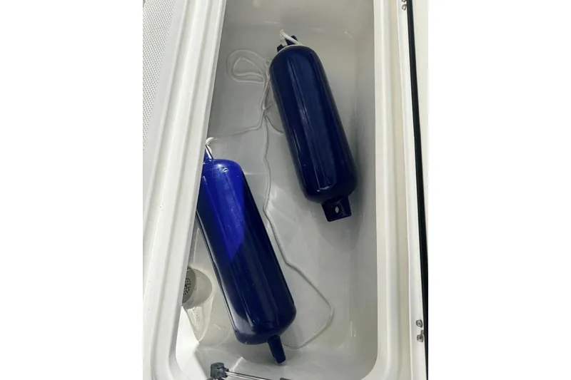 Slide: The Image of Blue boat fenders in storage compartment of 2026 World Cat 235 TE. - 17