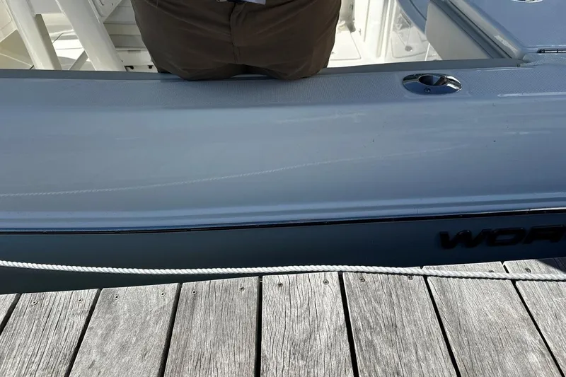 Slide: The Image of 2026 World Cat 235 TE boat docked, showing sleek design and deck details. - 19