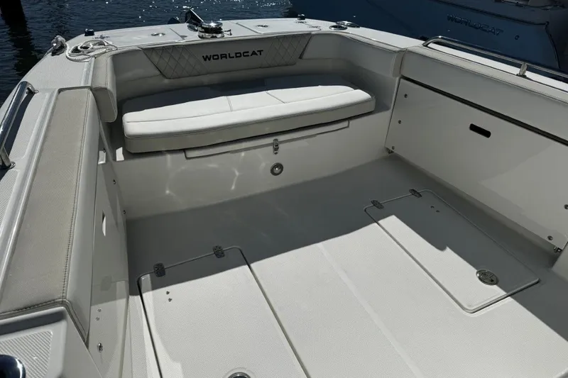 Slide: The Image of 2026 World Cat 235 TE boat interior with cushioned seating and storage compartments. - 8