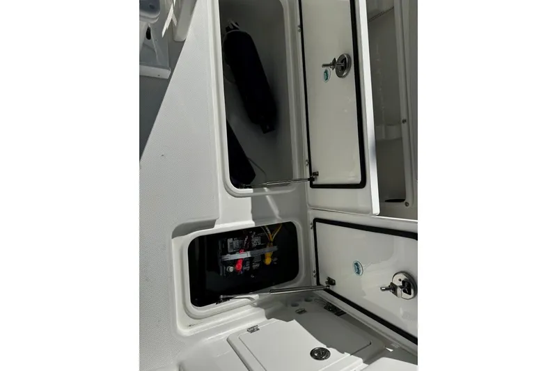 Slide: The Image of Open storage compartments on a 2026 World Cat 235 TE boat. - 18